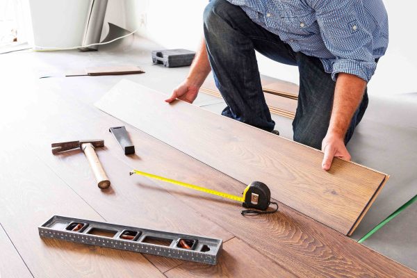 Man,Installing,New,Laminated,Wooden,Floor